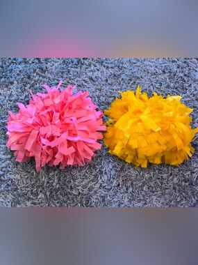 Brand New Pink and Yellow Plastic Poms Poms